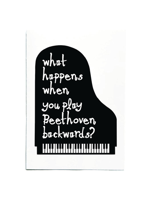 A white rectangular card or print featuring a black grand piano silhouette with white handwritten-style text that reads, 'what happens when you play Beethoven backwards?' and a small piano-key graphic at the bottom.